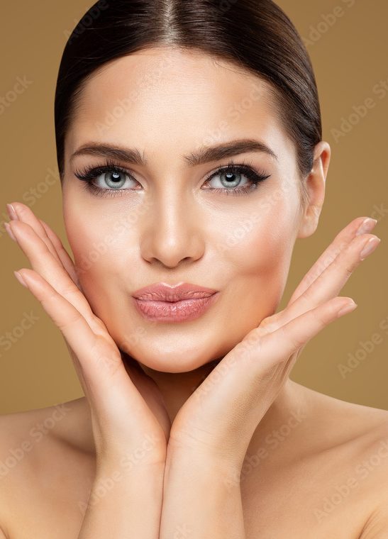 Beauty Model showing Cheekbones and Full Lips. Beautiful Woman Face Skin Care. Women Dermal Filler and Permanent Make up Cosmetology. Lip Augmentation Facial Lifting Spa Massage