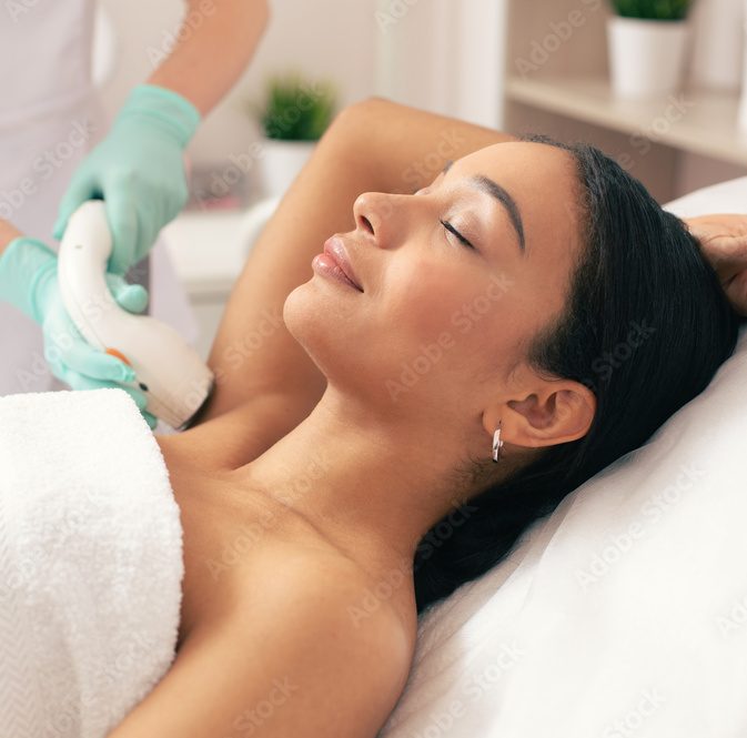 Young woman relaxing at the laser hair removal procedure